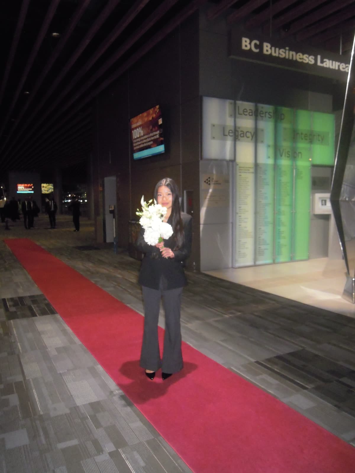 Red carpet, holding flowers, a quiet moment